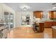 Eat-in kitchen with bar stool seating open to a living room with fireplace at 3190 Ward Ct, Wheat Ridge, CO 80215