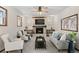 Inviting living room with fireplace, exposed brick, and plenty of natural light at 3190 Ward Ct, Wheat Ridge, CO 80215
