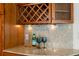 Wet bar featuring wine rack, granite countertops, under-cabinet lighting and room for entertaining at 3190 Ward Ct, Wheat Ridge, CO 80215