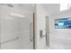 Bright bathroom features a spacious glass shower with grab bar and a soaking tub at 6102 E Yale Ave, Denver, CO 80222