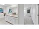 Bathroom with double sinks, tile flooring, and bright lighting at 6102 E Yale Ave, Denver, CO 80222