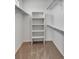 Walk in closet features shelving and neutral carpet at 6102 E Yale Ave, Denver, CO 80222