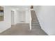 Entryway features a carpeted staircase and access to other rooms in the home at 6102 E Yale Ave, Denver, CO 80222