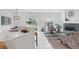 Modern eat-in kitchen features a breakfast bar that leads into a neutral living area with a fireplace at 6102 E Yale Ave, Denver, CO 80222