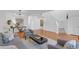 Neutral living room features hardwood floors, a modern couch, lots of natural light, and a staircase at 6102 E Yale Ave, Denver, CO 80222