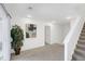 Bright living room boasts neutral carpet, artful decor, and stairs leading to the upper level at 6102 E Yale Ave, Denver, CO 80222