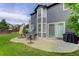 Exterior view of home with patio area, sliding glass doors, and an outdoor grill at 8915 Edgewood Ln, Highlands Ranch, CO 80130