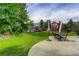 Large backyard features a green lawn, a patio area, and a wood fence at 8915 Edgewood Ln, Highlands Ranch, CO 80130