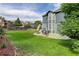 Landscaped backyard features a well-maintained lawn and patio furniture on a concrete patio at 8915 Edgewood Ln, Highlands Ranch, CO 80130