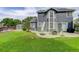 Large backyard featuring a well-maintained lawn, patio area, and storage shed, ideal for outdoor activities at 8915 Edgewood Ln, Highlands Ranch, CO 80130