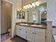 Bright bathroom showcasing double sinks, ample counter space, and modern lighting fixtures at 8915 Edgewood Ln, Highlands Ranch, CO 80130