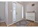 Inviting entryway featuring a white front door, wood floors and decorative storage cabinet at 8915 Edgewood Ln, Highlands Ranch, CO 80130