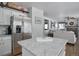 Spacious kitchen overlooking the living room, featuring granite counters and stainless steel appliances at 8915 Edgewood Ln, Highlands Ranch, CO 80130