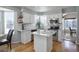 Bright kitchen featuring white cabinets, stainless steel appliances, granite countertops, and hardwood floors at 8915 Edgewood Ln, Highlands Ranch, CO 80130