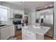 Well-appointed kitchen with white cabinets, granite countertops, stainless steel appliances at 8915 Edgewood Ln, Highlands Ranch, CO 80130