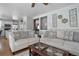 Comfortable living room with hardwood floors flowing into the adjacent kitchen for easy entertaining at 8915 Edgewood Ln, Highlands Ranch, CO 80130