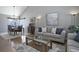 Cozy living room with hardwood floors, a comfortable sofa, and a dining area in an open-concept design at 8915 Edgewood Ln, Highlands Ranch, CO 80130