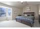 Serene main bedroom boasting a large window, plush carpet, and a comfortable bed at 8915 Edgewood Ln, Highlands Ranch, CO 80130