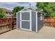 Outdoor storage shed features a gray exterior, white trim, and a concrete foundation at 8915 Edgewood Ln, Highlands Ranch, CO 80130