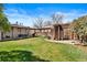 Spacious backyard featuring a lush lawn, patio area, pergola, and well-maintained landscaping at 3319 E 27Th Ave, Denver, CO 80205