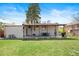 Wide backyard featuring an outdoor seating area under a covered porch and a lawn at 3319 E 27Th Ave, Denver, CO 80205
