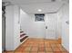 Basement space with terracotta tile flooring, a small window, and an open door at 3319 E 27Th Ave, Denver, CO 80205