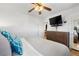 Cozy bedroom with light gray bedding, wood floors, and dresser at 3319 E 27Th Ave, Denver, CO 80205