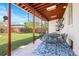 Cozy covered patio with metal patio set and view of lush green lawn at 3319 E 27Th Ave, Denver, CO 80205