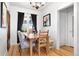 Cozy dining area featuring a light-wood table, window and elegant chandelier at 3319 E 27Th Ave, Denver, CO 80205