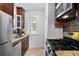 Well-lit kitchen with stainless steel appliances, granite countertops, and mosaic tile backsplash at 3319 E 27Th Ave, Denver, CO 80205