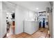Laundry room with washer, dryer, and access to living room with fireplace at 3319 E 27Th Ave, Denver, CO 80205
