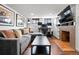 Cozy living room with gray sofa, brick fireplace, and a dedicated work space at 3319 E 27Th Ave, Denver, CO 80205