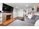 Living room featuring a brick fireplace, TV, shelving and comfortable gray sofa at 3319 E 27Th Ave, Denver, CO 80205