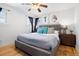 Bedroom featuring a ceiling fan, wood flooring, natural lighting, and decor at 3319 E 27Th Ave, Denver, CO 80205