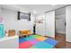 Bright playroom features a colorful playmat and ample storage space for toys at 3319 E 27Th Ave, Denver, CO 80205