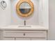 Modern bathroom vanity with a stylish round mirror, a clean design, and bright lighting at 789 N Clarkson St # 406, Denver, CO 80218