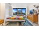 Bedroom featuring a Murphy bed, couch, and large windows with city views at 789 N Clarkson St # 406, Denver, CO 80218