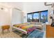 Bright bedroom with a Murphy bed, couch, and large windows, offering a versatile space at 789 N Clarkson St # 406, Denver, CO 80218