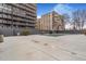 Spacious pool deck area with large concrete surface and view of surrounding high-rise buildings at 789 N Clarkson St # 406, Denver, CO 80218