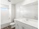 Modern bathroom features a vanity, undermount sink, a large mirror, and a shower-tub combo at 571 Homestead Ave, Brighton, CO 80601