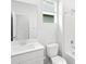 Clean bathroom featuring a white vanity, toilet, tub, and shower combo with a window at 571 Homestead Ave, Brighton, CO 80601
