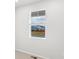 Bright bedroom features a window with blinds, providing a view of the neighborhood at 571 Homestead Ave, Brighton, CO 80601