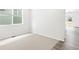 Well-lit bedroom with neutral carpet, large window, and view of the home's exterior at 571 Homestead Ave, Brighton, CO 80601