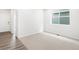 Bright bedroom with neutral carpet and a large window providing natural light at 571 Homestead Ave, Brighton, CO 80601