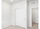 Bright bedroom features neutral carpet, white walls, and closet with sliding doors for organized storage at 571 Homestead Ave, Brighton, CO 80601
