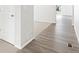 Hallway featuring luxury vinyl plank flooring transitions to carpet at 571 Homestead Ave, Brighton, CO 80601