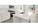 A kitchen featuring an island with a sink and modern countertops at 571 Homestead Ave, Brighton, CO 80601