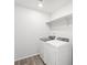 Convenient laundry room with a washer, dryer, and storage shelf at 571 Homestead Ave, Brighton, CO 80601