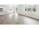 Open-concept living area featuring wood-look floors, recessed lighting and large windows at 571 Homestead Ave, Brighton, CO 80601