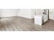 Open concept living space with wood-look floors, with stairs, and view into the kitchen at 571 Homestead Ave, Brighton, CO 80601